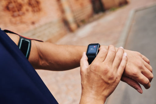 Cloe-up image of sportsman checking his pulse on smart watch